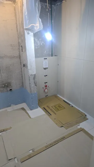 Bathroom at first-fix stage: concealed cistern frame and wall boards