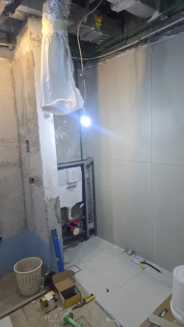 Bathroom at first-fix stage: concealed cistern frame and wall boards