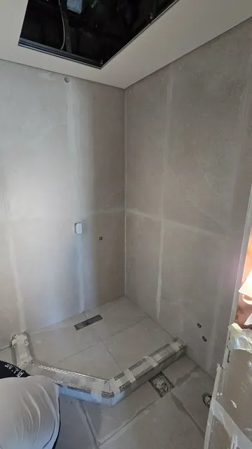Bathroom at first-fix stage: concealed cistern frame and wall boards
