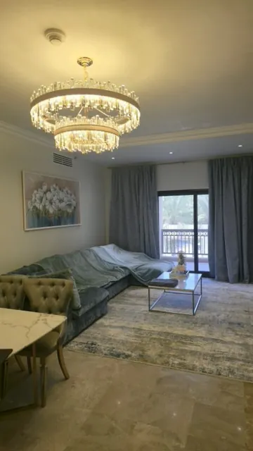 Living room after the renovation: marble floor, chandelier, curtains