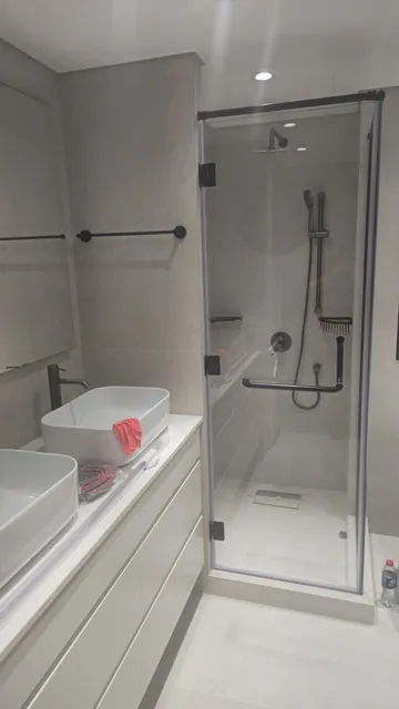 Shower room with walk-in glass screen and backlit mirror