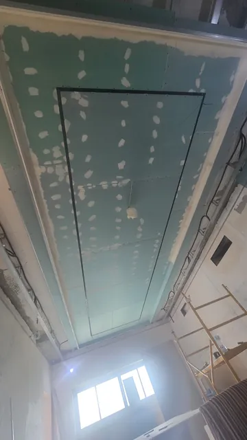 Suspended ceiling with light coves, taped and ready for finishing