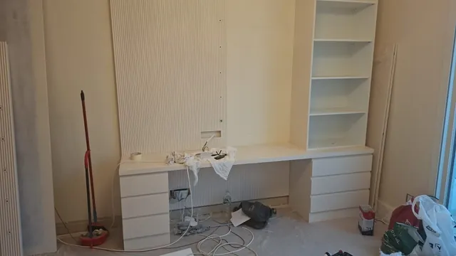 Bespoke joinery being installed: dressing table and shelving