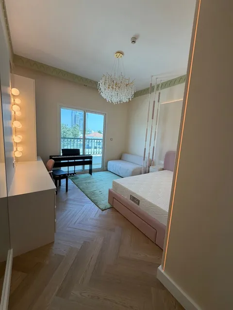 Bedroom with herringbone parquet, bespoke dressing table and chandelier